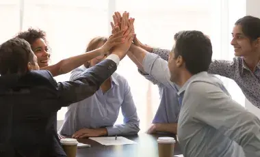 group of business people high fiving 