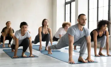 group of people in runner lunge on mats 