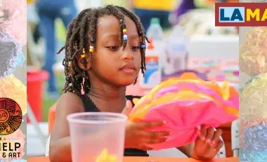 young girl making a paperflower