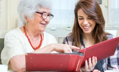 adult reading with senior