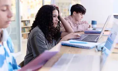 Students studying and using their laptops
