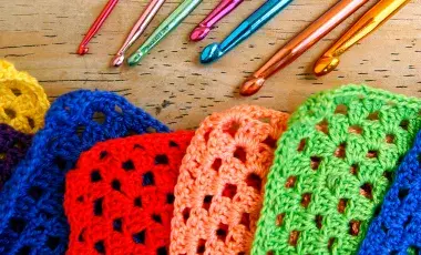 colorful crochet squares and crochet hooks