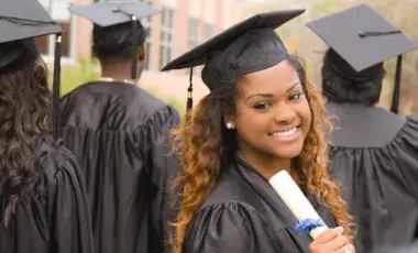 Young woman graduate with other graduates