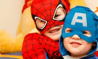 two kids in super heroes costumes
