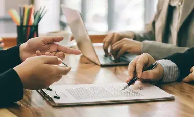 shows people consulting with devices on a table