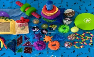 On a blue background are sensory toys such as fidgets and squishies.