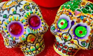 Image of two decorated sugar skulls. 