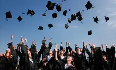 College graduates throwing caps in the air