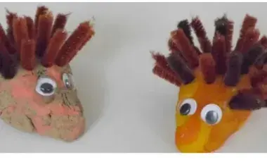 Porcupine craft made with clay, googly eyes, and chenille sticks