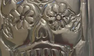 closeup image of a silver skull mask made from tin