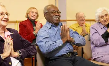 Adults doing seated exercises