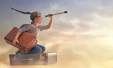 girl flying through the air on suitcase
