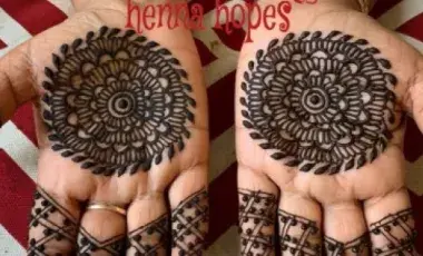 Image of two hands face up with henna tattoos. 