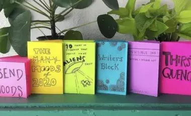 collection of colorful zines on a table