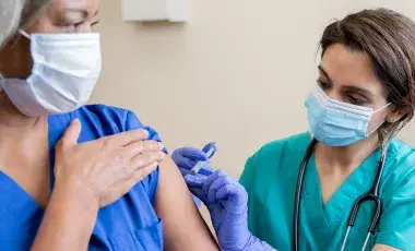 healthcare worker vaccinating a person