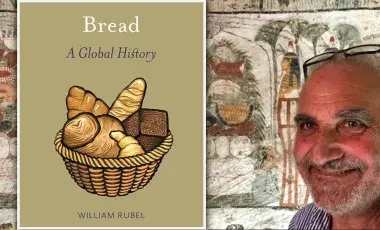 William Rubel in front of an ancient Egyptian artwork depicting a feast