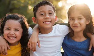 3 children with arms around each other
