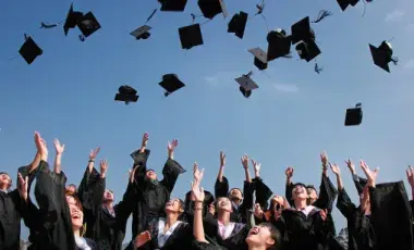 Graduates throwing caps in the air 