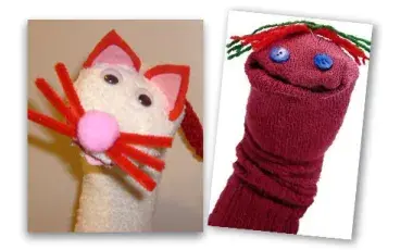 White sock puppet with pointy ears and whiskers and red sock with button eyes and yarn hair