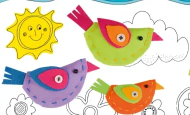 Colorful fabric birds against a cartoon sunshine and cloudy sky