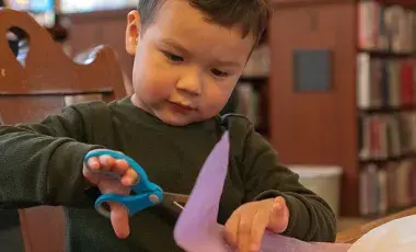 child cutting paper