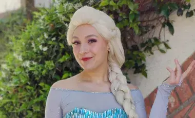 Female with blonde wig and blue princess dress