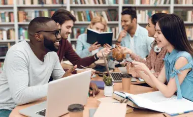Group of adults meeting with laptops