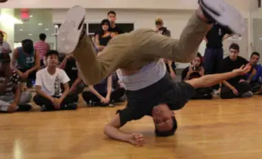 Break dancer spinning on his head. 