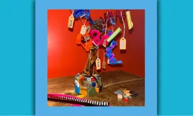 Image of a craft that looks like a tree made with recycled materials.