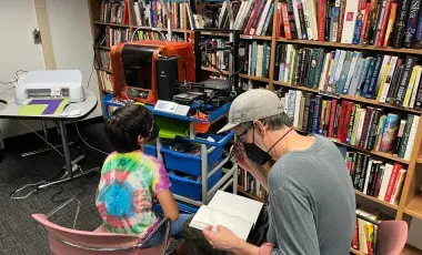 Father son sit by 3F printer