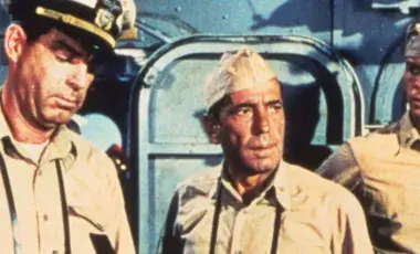 three military men in naval uniforms on a the U.S war ship