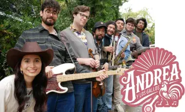 The band Andrea Y Los Gallos are outside in a green, leafy setting with a guitar and drumsticks