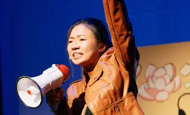 woman with megaphone on stage