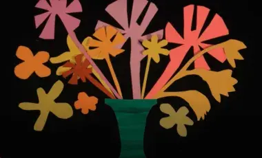 colorful flowers cut out of construction paper on a black background