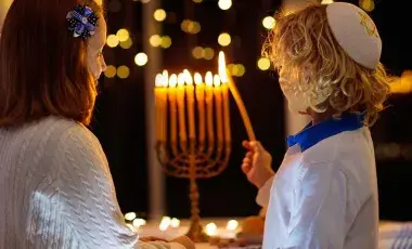 children lighting a Menorah