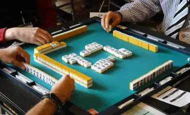 Image of players playing mah jonng