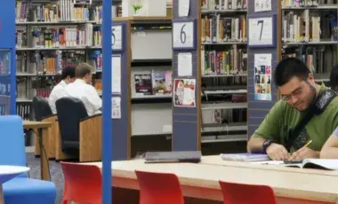 Two teens studying and reading in a designated Student Zone area.