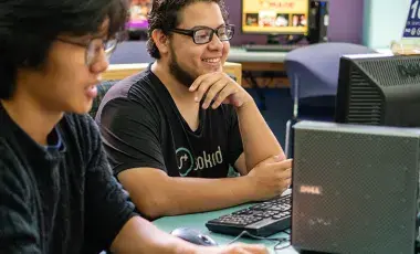 teens smiling at computers