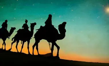 sunset and three kings on camels silhoutte on desert 