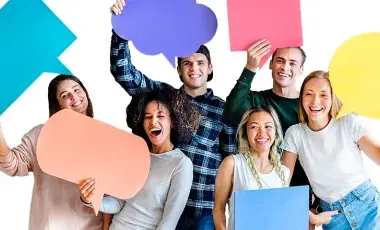 Six young people stand in a group against a white background. They are smiling and holding large thought bubbles of different colors.