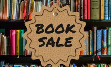a bookshelf with the text "Book Sale" in the center