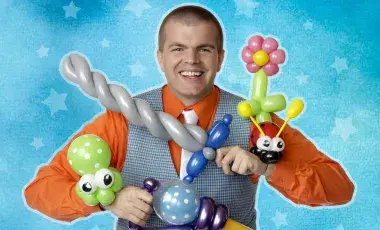 Male performer with several balloon creations in his hands