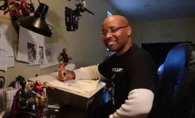 Evan seated in his drawing studio