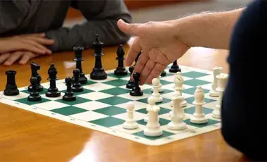a chess board with two players actively playing a game of chess