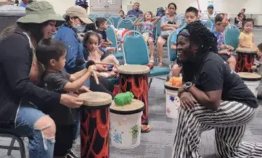 A drum circle with kids and their parents