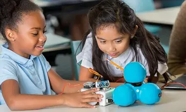 two girls working on STEM car