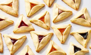 A plate of Hamantaschen (triangular jam-filled cookies)