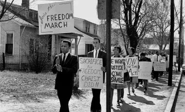 men and women marching holding signs 