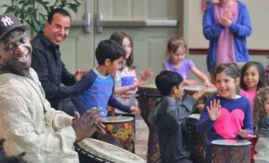 Happy people drumming together