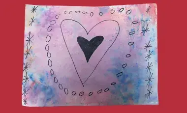  A heart drawn in black sharpie on a watercolor background.